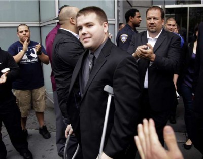 Killer cop Richard Haste is applauded by his fellow white NYC cops as he leaves court.