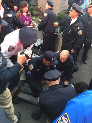 Police mob protester as arrest is made. Photo: George Joseph