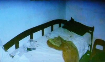 Bed under which witness Valerie Glover hid.