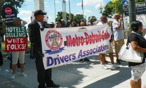 Kenneth  leads march with cab drivers' banner.