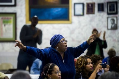 Flint resident Barbara Griffith-Wilson screams out an amen as she stands up out of her seat to show solidarity with a number of Flint City Council members that speak their minds during a call for the removal of Emergency Manager Darnell Earley on Monday, Oct. 6, 2014 at Antioch Missionary Baptist Church in Flint. Jake May | MLive.com
