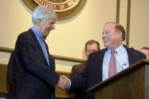 Michigan Gov. Rick Snyder and Detroit Mayor Mike Duggan congratulate each other on bankruptcy approval.