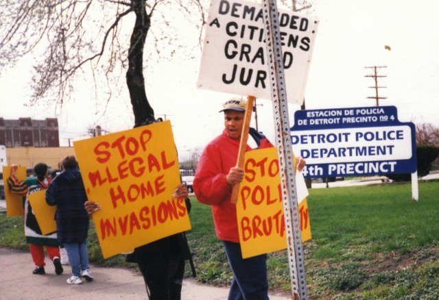 Cornell Squires (r) and supporters of his son and young cousins who had been framed up by “Robocop” William Melendez march on Detroit’s old 4th Precinct in 2000. This was 3 years before the feds charged Melendez and 17 other cops with running a Ramparts-style ring that terrorized the southwest side. Squires’ son was falsely accused of attempted carjacking; his young cousins’ home was invaded by Detroit police who planted drugs there. Squires himself was previously assaulted by Detroit cop Robert Feld, a beating which Squires father Eugene Squires and mother Vester Squires stopped.His father had a heart attack which later proved fatal.