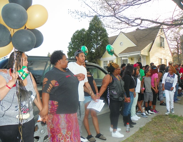 Family members and friends held hands in a large circle that surrounded both front yards.