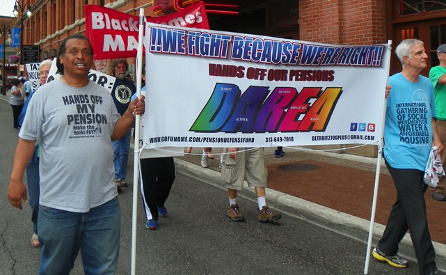 Bill Davis, President of DAREA (l) carries banner at Wayne County tax foreclosure protest June 8, 2015.