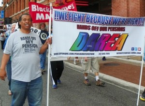 DAREA Pres. Bill Davis carries banner at tax foreclosure protest June 8, 2015.