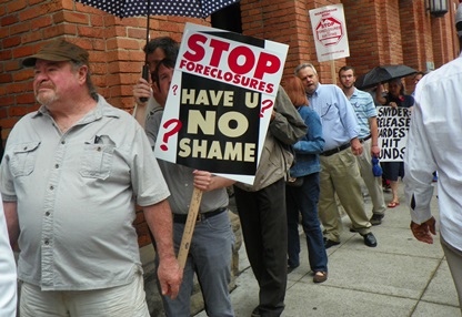 Have you no shame? protesters ask Treasurer, county officials.