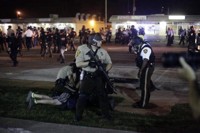Ferguson police detain protester Aug. 18, 2014, nine days after Mike Brown was killed Aug. 9, 2014.